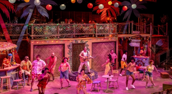 (center) Bryan Acker and members of the cast in JIMMY BUFFETT’S ESCAPE TO MARGARITAVILLE from Music Theater Works, now playing through November 1 in the North Theatre at the North Shore Center for the Performing Arts in Skokie.