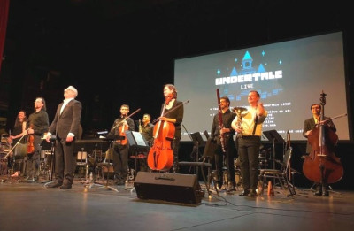 Conductor Eric Roth takes a bow with musicians following the performance.